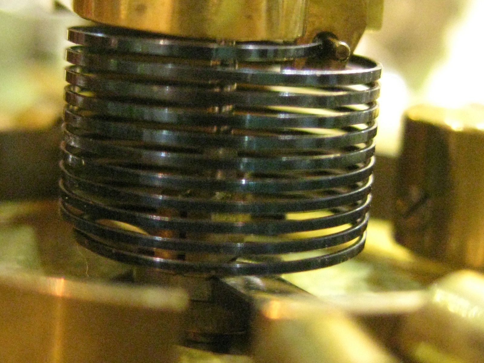 Primer plano del muelle espiral y componentes internos de un reloj antiguo, mostrando el sistema mecánico de precisión.